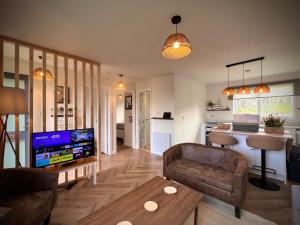 a living room with a couch and a tv at Farr Bay Inn in Bettyhill