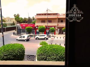 a view of a street with cars in a parking lot at Hôtel Jodesa in Laayoune