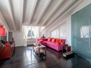 a living room with a purple couch and a table at Apartment Verney by Interhome in Albisola Superiore