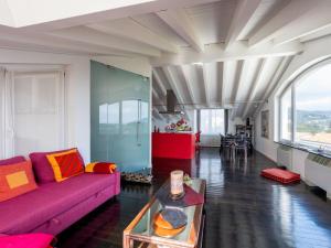 a living room with a purple couch and a table at Apartment Verney by Interhome in Albisola Superiore