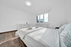Postel nebo postele na pokoji v ubytování PEARL09 Appartement spacieux près de Bienne 2D