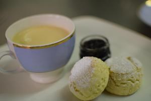 two donuts and a cup of coffee on a table at The Dolphin Inn in Thorpeness