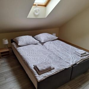 a bed with two pillows on it in a room at Apartament centrum Jura Żarki in Żarki