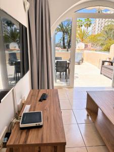 a room with a table with a laptop on it at Estudio en Paraiso Royal in Arona +12 photos