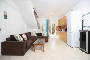 a living room with a couch and a table at Holiday Apartment Fourka in Skala Fourkas