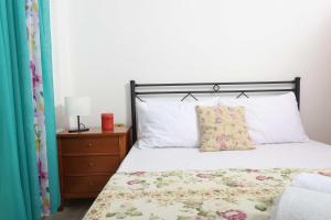 a bedroom with a bed with white sheets and a pillow at Holiday Apartment Fourka in Skala Fourkas