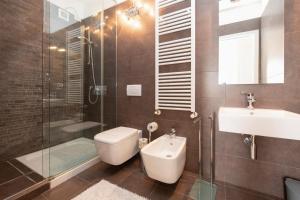 a bathroom with a toilet and a sink and a shower at MGH Luxury - Residenza La Perla Peschiera Lakefront in Peschiera del Garda +21 photos