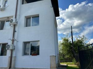 a white building with windows on the side of it at Стаи за гости Крис in Vratsa