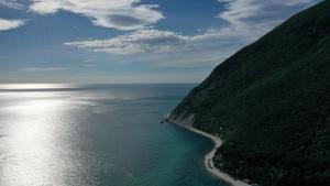 an aerial view of the ocean next to a mountain at VVR6 Apartment by Homes in Ancona in Ancona +3 photos