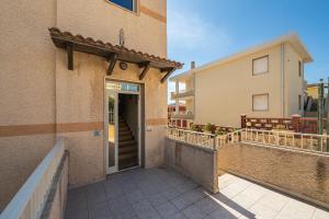 a door to a building with a balcony at AffittaSardegna - Quadri Alba in Castelsardo