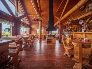 a restaurant with wooden tables and chairs in a building at Apartmán Lesana in Nová Lesná