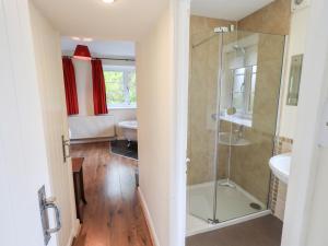 a bathroom with a glass shower and a toilet at The Old Chapel in Windermere +23 photos