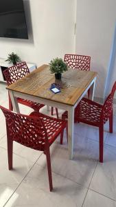 a table with two chairs and a potted plant on it at AH - Rayito II - Confort y diseño bajo el sol de Maspalomas in Maspalomas