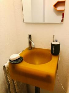 a bathroom sink with a soap dispenser on it at Rustico Il Nove in Piazzogna