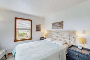 a bedroom with a large bed and a window at Tarpon Drive Hideaway MASTER in Avon