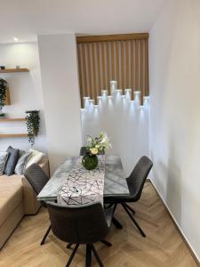 a dining room with a table and chairs and a couch at Sea & Luxury in Perea +3 photos