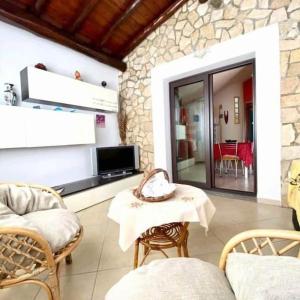 a living room with a table and chairs at Villa Arbatax 200m from the Sea with Parking in Àrbatax