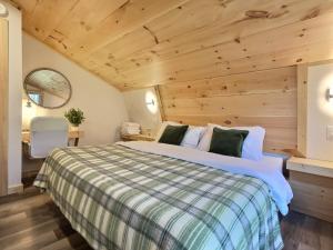 a bedroom with a bed and a wooden ceiling at HappyCub- AC, Hot Tub, Fire Pit, Game Room! in Killington +31 photos