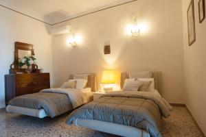 ein Schlafzimmer mit 2 Betten, einer Kommode und einer Lampe in der Unterkunft Residence Mareluna - Amalfi Coast in Vietri