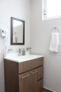 a bathroom with a sink and a mirror at Lofts Las Fuentes in Guadalajara +146 photos