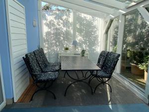 a table and two chairs on a screened porch at The Golfers Blue in Unter Göhren
