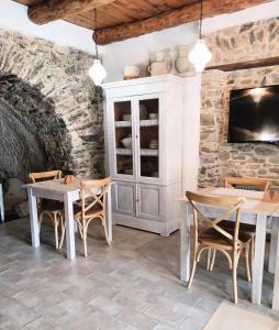 a dining room with tables and chairs and a tv at La Casa della Filanda in Belmonte Calabro +57 photos
