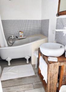 a bathroom with a white tub and a sink at La Casa della Filanda in Belmonte Calabro