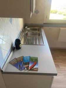 two books are sitting on a counter in a kitchen at Casa Belvedere in Sasso Pisano +6 photos