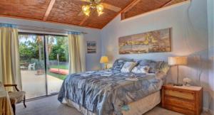 a bedroom with a bed and a sliding glass door at lone pine estate in Delray Beach +10 photos