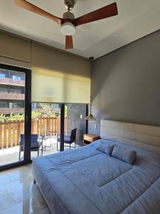 a bedroom with a large bed and a ceiling fan at Hideaway in Tulum Hotel Zone in Tulum