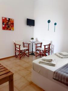 a room with a bed and a table and chairs at Mar-Nik Village in Paliochori