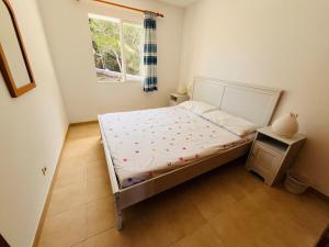 a small bedroom with a bed with a window at Apartamento en Son Parc in Son Parc +16 photos
