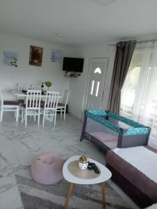 a living room with a couch and a table at Vikendica Bambi - Vrdnik in Vrdnik