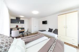a bedroom with a bed and a living room at Apartman Simic in Trogir +15 photos