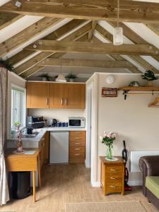 a kitchen with wooden cabinets and a table in a room at The Garden Room in Spittal