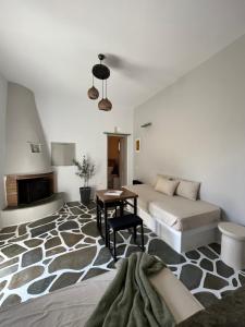 a bedroom with a bed and a table in a room at Lithari Traditional Apartment in Agios Sostis