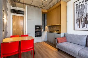a kitchen and a living room with a table and a couch at Новобудова в бізнес класі з краєвидом in Lviv +8 photos