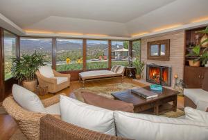 a living room with white furniture and a fireplace at Bella Vista by Paradise Retreats in Carpinteria