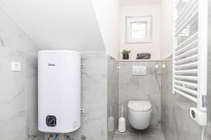a white bathroom with a toilet and a sink at Apartman Simic in Trogir +10 photos