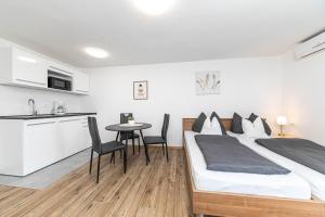 a bedroom with a bed and a table with chairs at Apartman Simic in Trogir