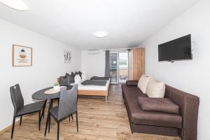 a living room with a couch and a table at Apartman Simic in Trogir