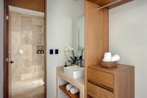 a bathroom with a sink and a shower at Lalola DownTown Boutique Apartments in Puerto Morelos