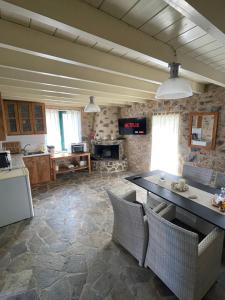 a kitchen with a table and chairs in a room at GuesthouseKamara in Monemvasia