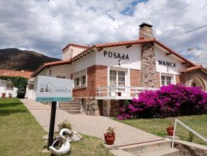 a building with a sign in front of it at Posada Mainca in Los Cocos +5 photos