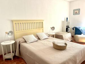 a bedroom with a large bed with a large headboard at Circobueno de Isla - 5609 in Arnuero