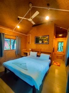 a bedroom with a large bed in a room at Monsoon Retreats Treehouse in Thekkady +12 photos