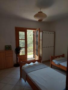Ένα ή περισσότερα κρεβάτια σε δωμάτιο στο Villa Foti