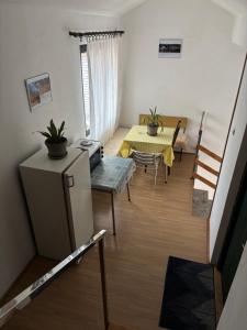 a living room with a table and a dining room at Lola in Prolomska Banja