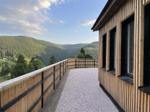 a balcony of a house with a view of the mountains at Bouda u vleku in Pec pod Sněžkou