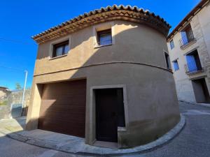 a building with a garage door on the side of it at Casa Bertolo in Radiquero +2 photos